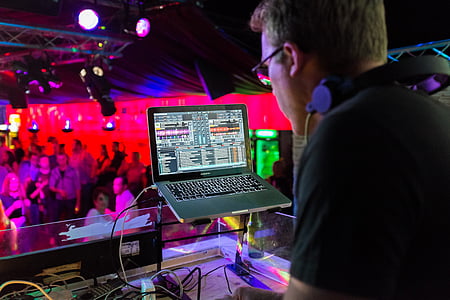 DJ playing music using laptop computer at the club