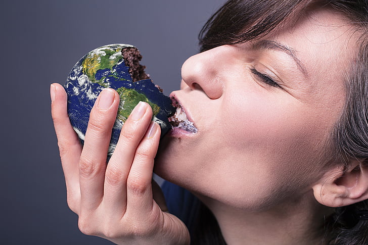 woman eating chocolate globe pastry