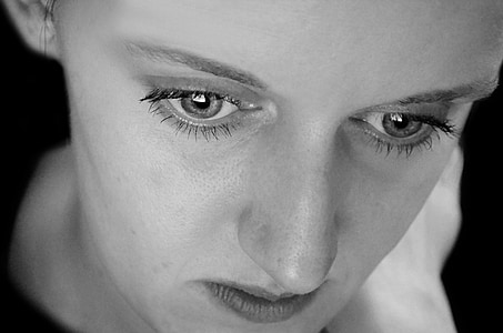 closeup grayscale photo of woman's face