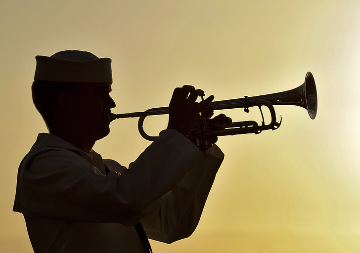 Royalty-Free photo: Silhouette of man playing wind instrument