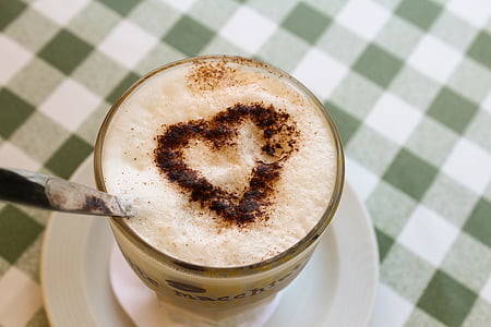 cappuccino with heart cinnamon designed on tabletop
