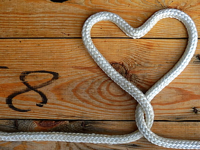flat lay photography of heart formed white rope