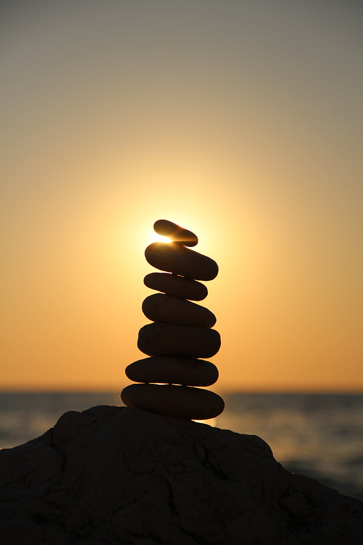 silhouette photography of stone balancing