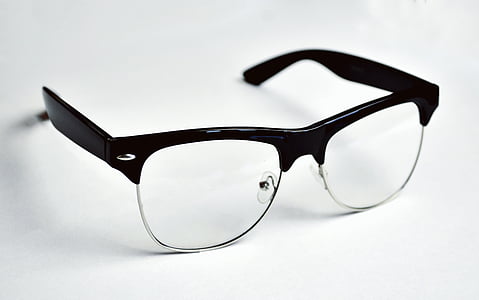 black clubmaster-style eyeglasses on white surface