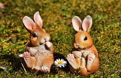 two squirrel figurines on grass field