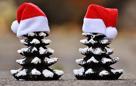 two black-and-white tree ornaments with hats