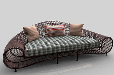brown wicker sofa with plaid cushion and three throw pillows