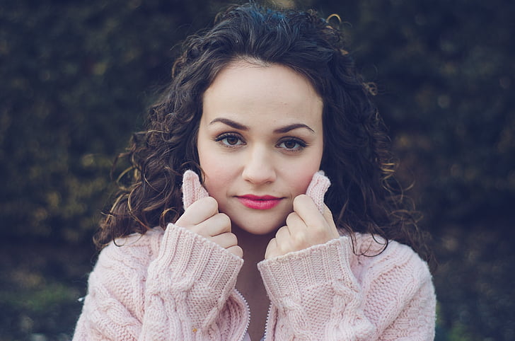 woman wearing pink cable-knit sweater