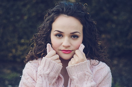 woman wearing pink cable-knit sweater