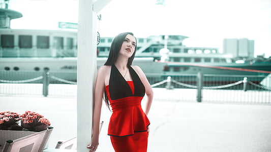 woman wears red and black sleeveless dress