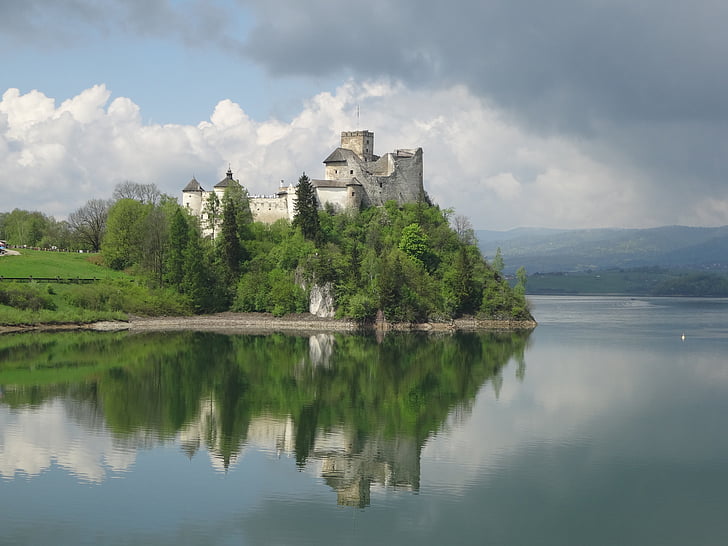 gray concrete castle near body of water during daytime
