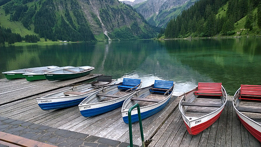 five red-white-and-blue fishing boats on wooden dock