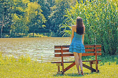 woman standing in front of bench