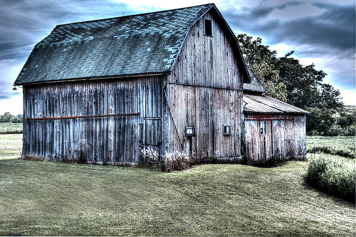 gray wooden shed under cloudy sky