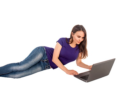 woman in purple shirt holding gray laptop computer