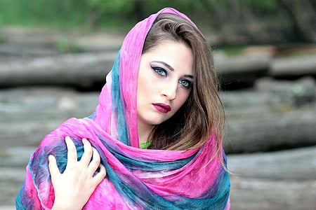 selective focus photography of woman wearing blue and pink shawl