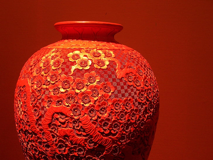focus photo of red floral ceramic vase