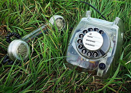 gray rotary dial telephone on grass