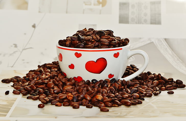 coffee beans on white and red ceramic mug