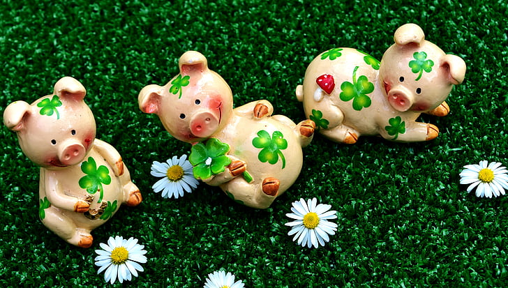 three pink ceramic pig figurines
