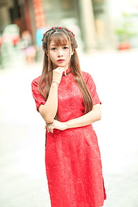 woman wearing red standing on park
