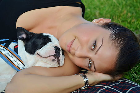 woman lying in grass with bulldoig