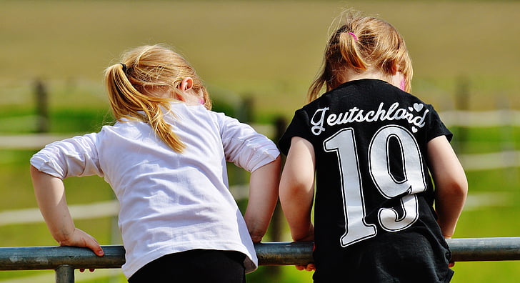 two girls wearing white and black shirts