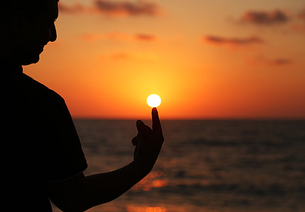 man pointing on sunset