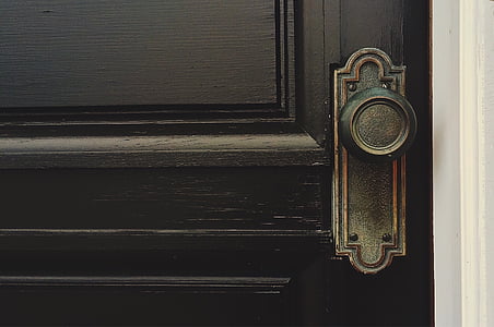 black wooden door with black metal door knob