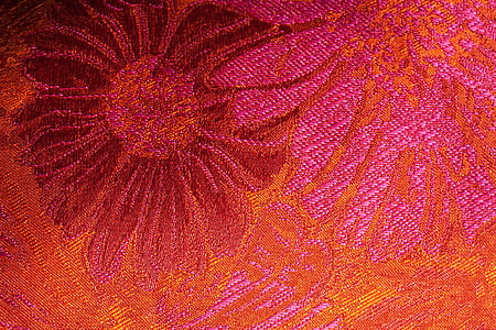 close-up photo of red and pink floral cloth