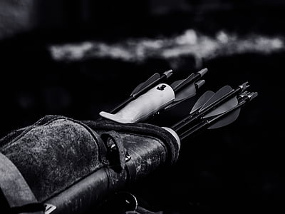 grayscale photo of arrows and quiver