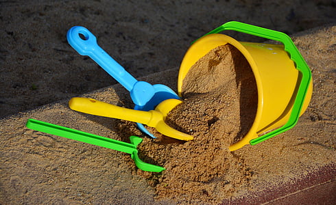 sand bucket and three assorted-color sand shovels
