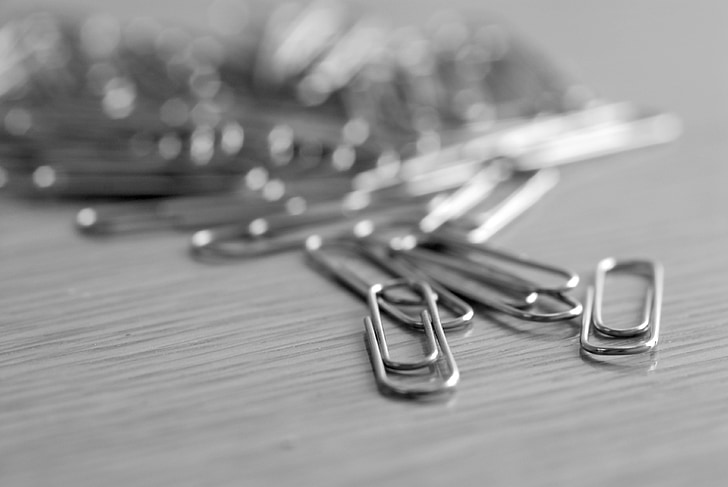 shallow focus photograph of gray paper clip lot