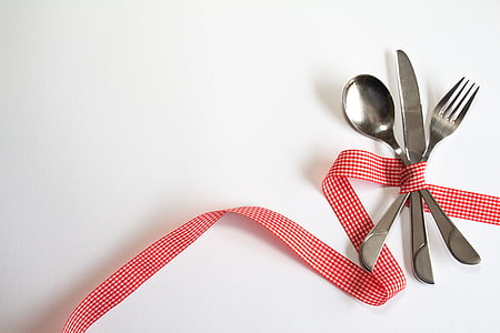 stainless steel fork, spoon, and knife with red and white gingham ribbon