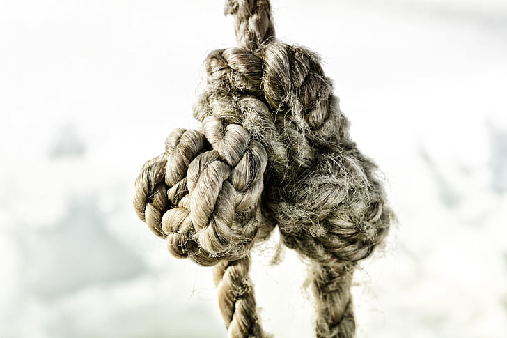 tied brown rope grayscale photo