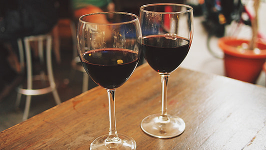 photo of two wine glasses filled with liquor