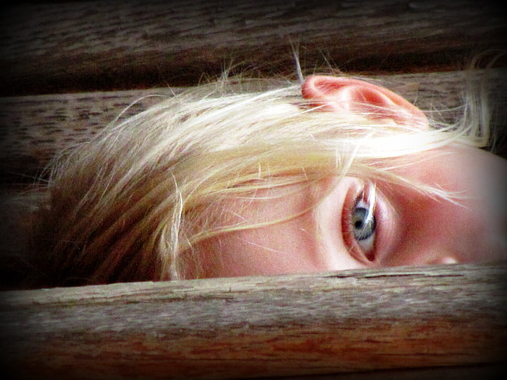 girl with blonde hair showing her eye