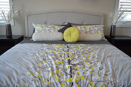 white and yellow bed sheet and pillow cases