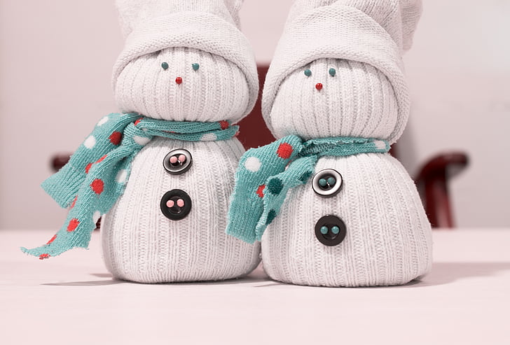 two white-and-teal snowman sock dolls