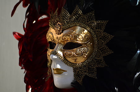 shallow focus photography of gold, black, and red masquerade mask