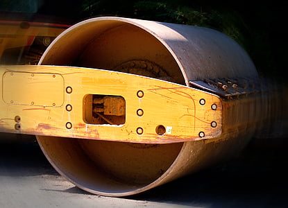 close-up photography of yellow and brown road roller