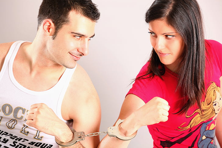 man and woman wearing handcuffs