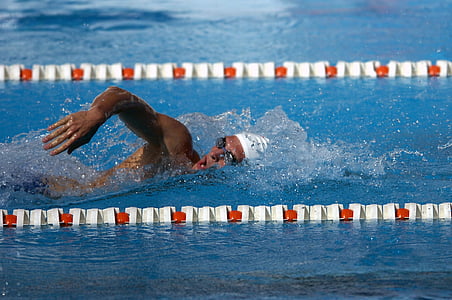 man in white swim cap on pool