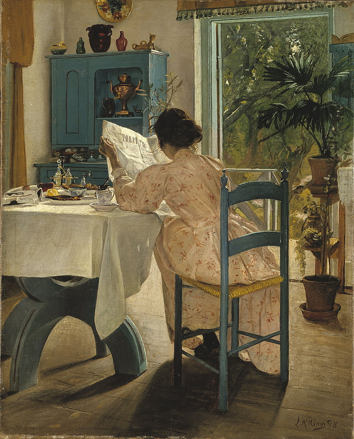 woman sitting on chair beside table