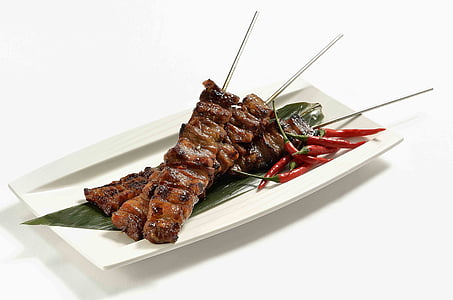 grilled meat served on white ceramic plate