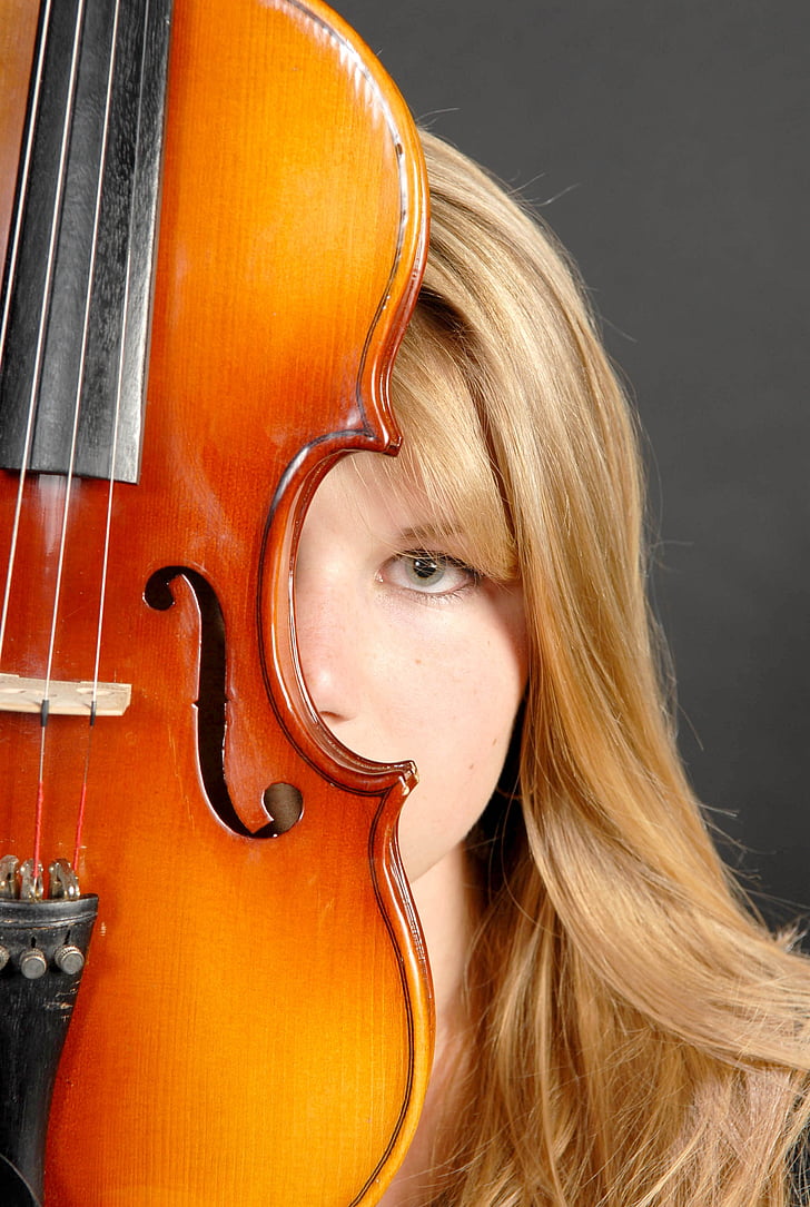 woman behind violin looking straight