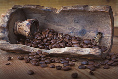 selective focus photography of coffee beans in brown wooden container