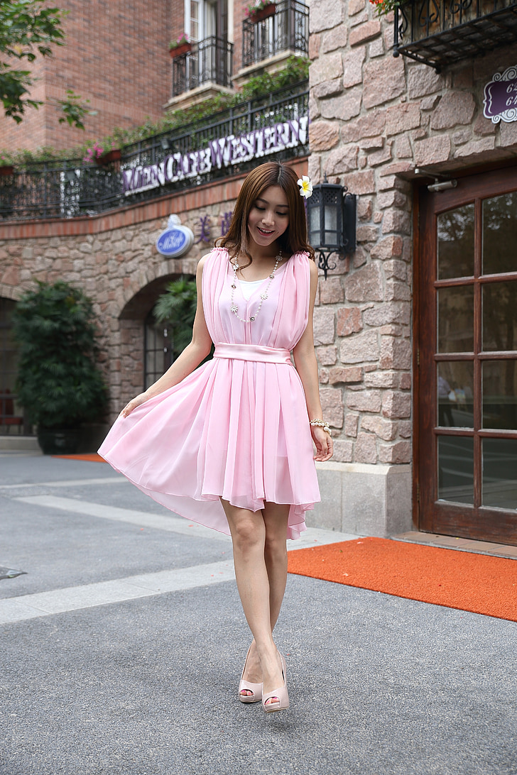 woman wearing pink mini dress outside coffee shop