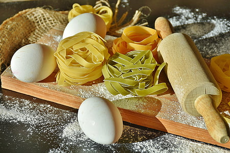 eggs and pasta with wooden rolling pin