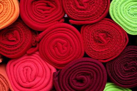 pile of assorted-color textile rolls